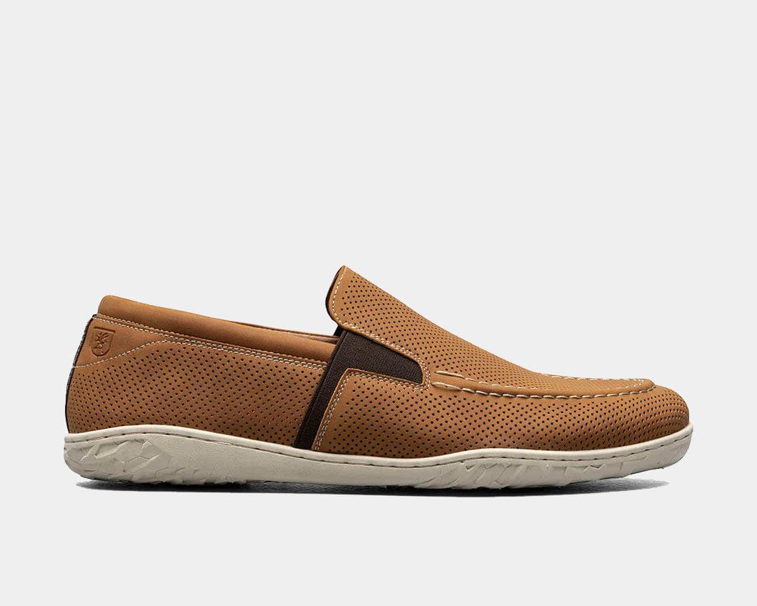 A Perforated Moc Toe Slip-On shoe in tan color with a micro-perfed upper and a modern, molded sole.