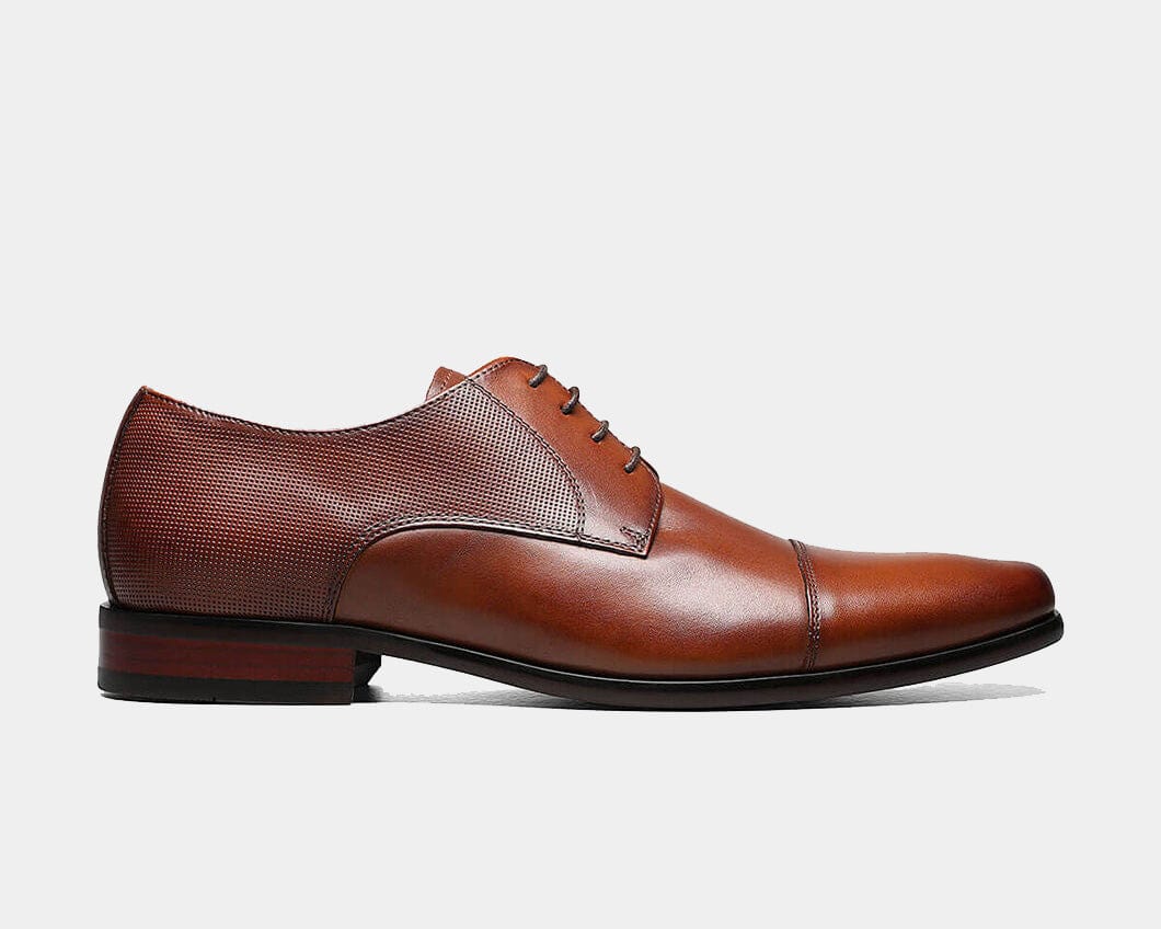A cognac Cap Toe Oxford shoe with a leather upper, chiseled toe, and micro-perfing on the collar and heel.