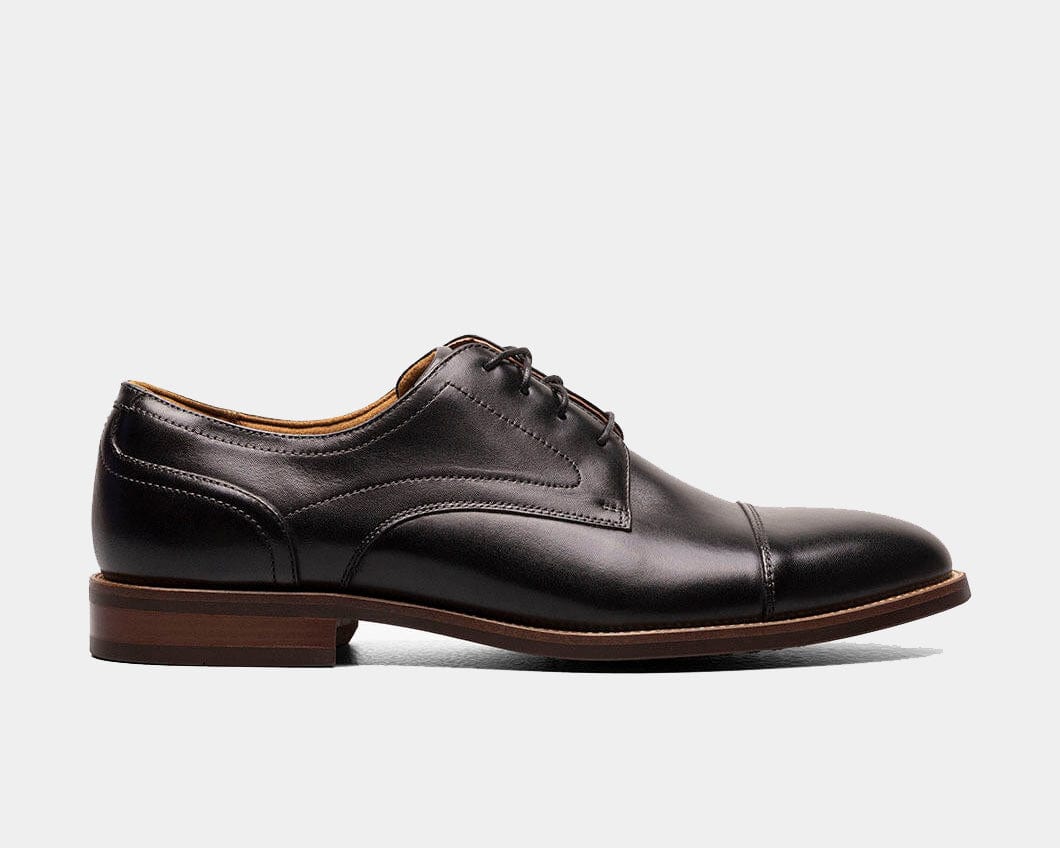 A black Oxford shoe with a smooth leather upper and a cap toe style.