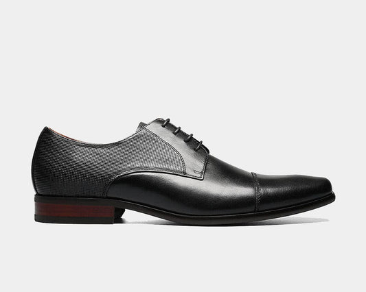 A black Cap Toe Oxford shoe with a leather upper, chiseled toe, and micro-perfing on the collar and heel.