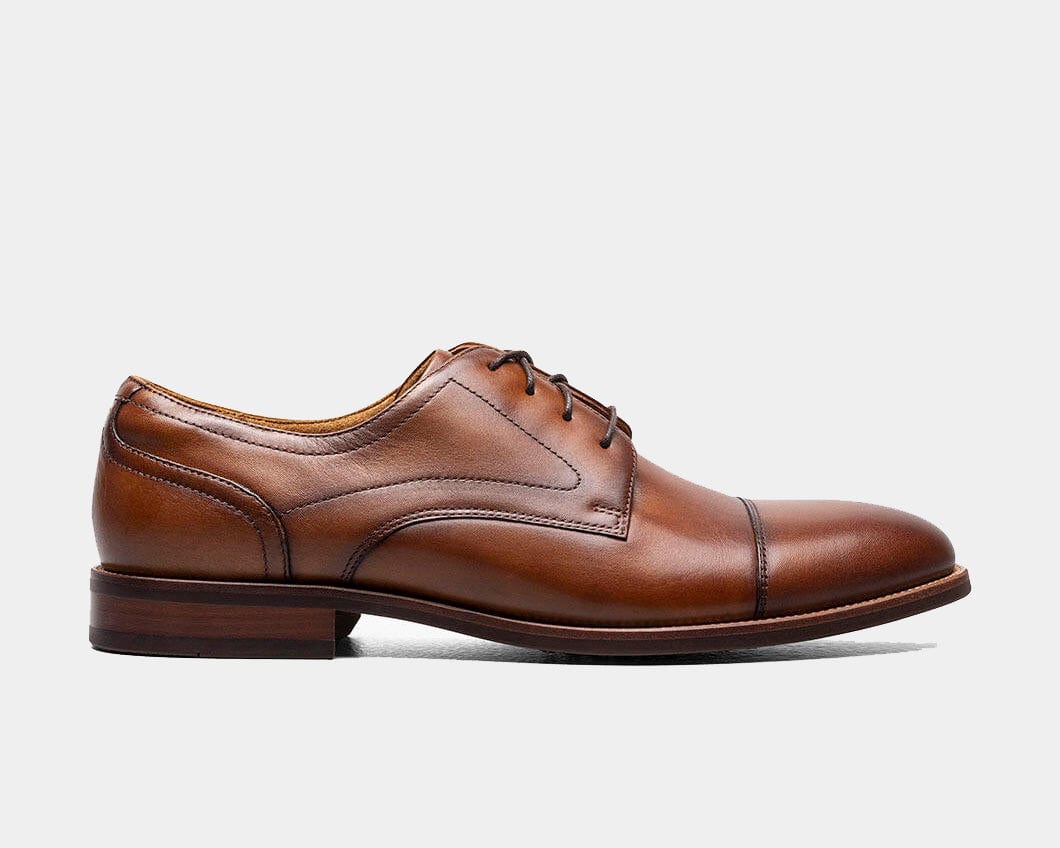 A cognac Oxford shoe with a smooth leather upper and a cap toe style.