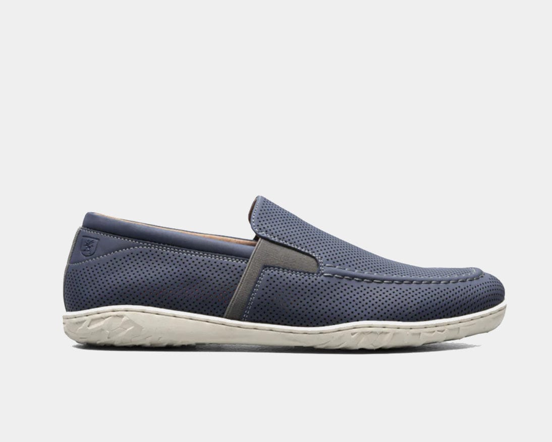 A Perforated Moc Toe Slip-On shoe in navy color with a micro-perfed upper and a modern, molded sole.