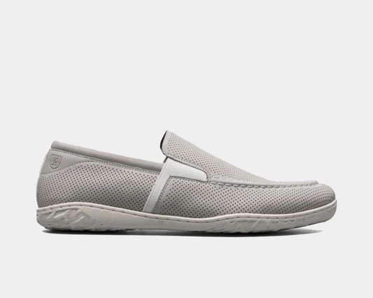 A Perforated Moc Toe Slip-On shoe in white color with a micro-perfed upper and a modern, molded sole.