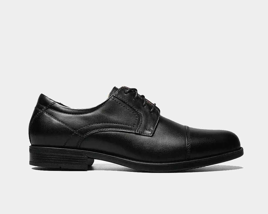 A black leather Oxford shoe with a cap toe style and lace-up closure.