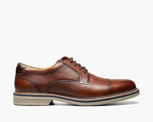A cognac Cap Toe Oxford shoe with a two-tone welt and lace-up closure.