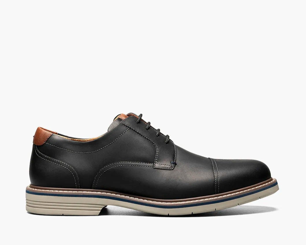 A black Cap Toe Oxford shoe with a two-tone welt and lace-up closure.