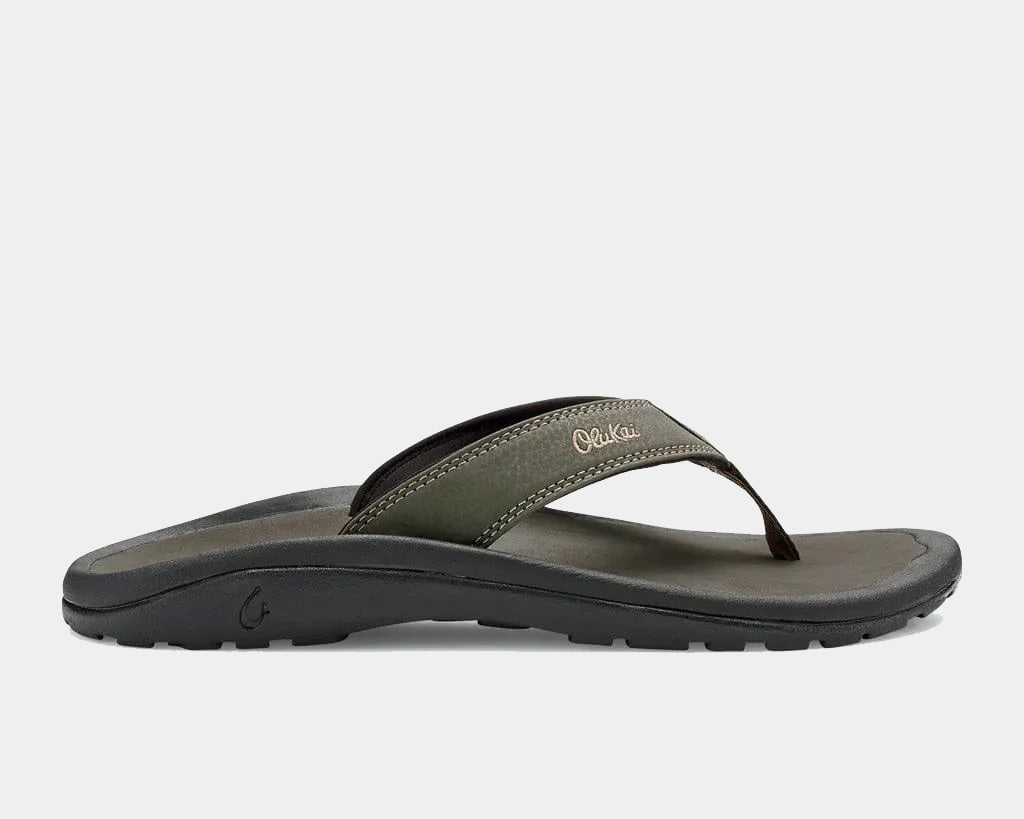 A pair of olive brown Ohana sandals by Olukai, featuring a water-resistant synthetic strap and a non-marking rubber outsole with a coral reef lug design.