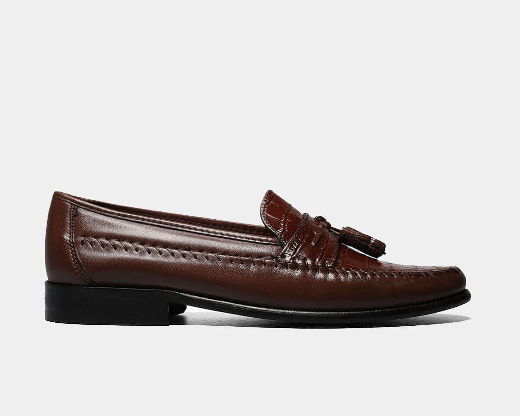 A burgundy Moc Toe Tassel Loafer with a leather upper and a non-leather sole.