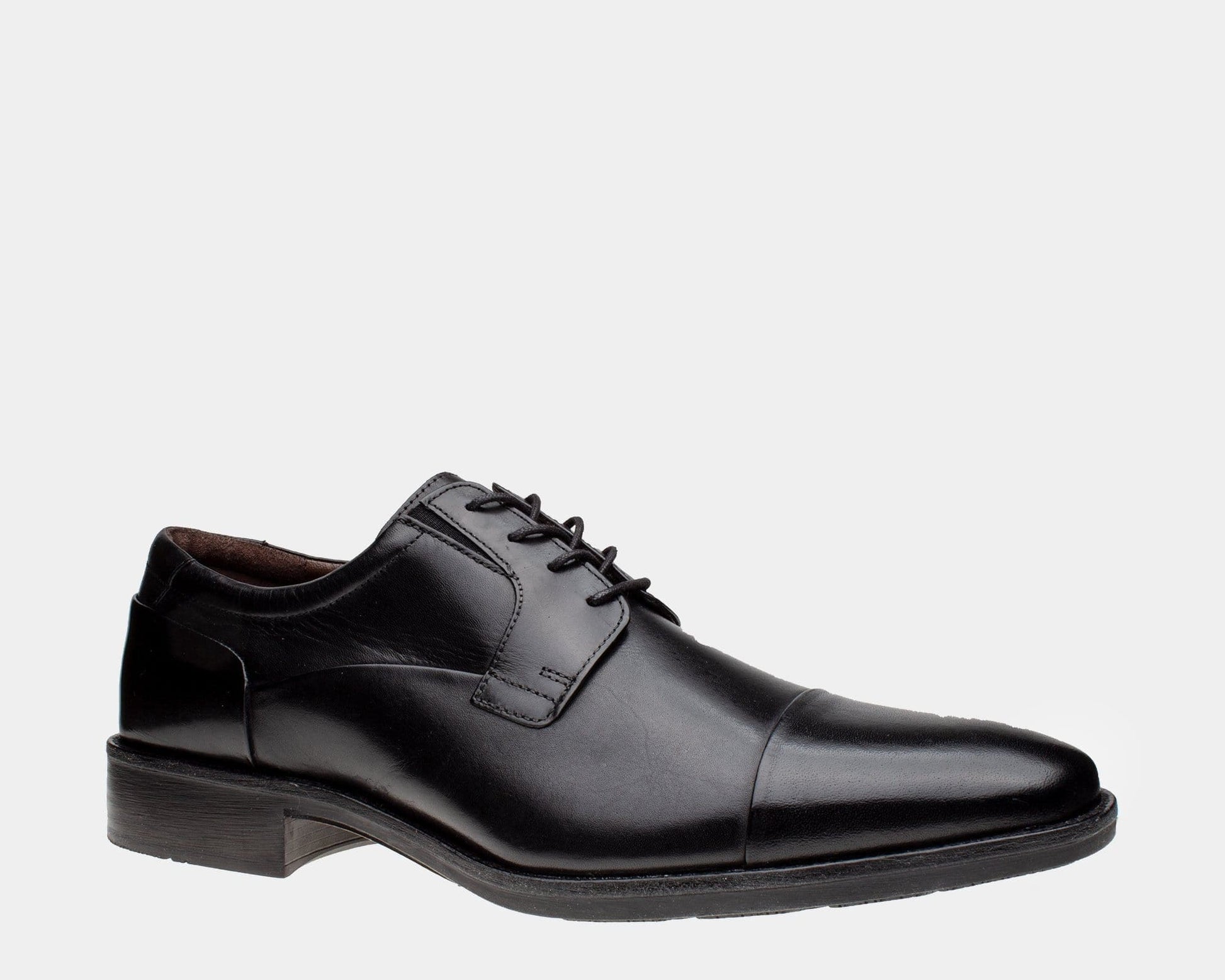A black leather cap toe Oxford shoe with a cushioned footbed and rubber outsole.