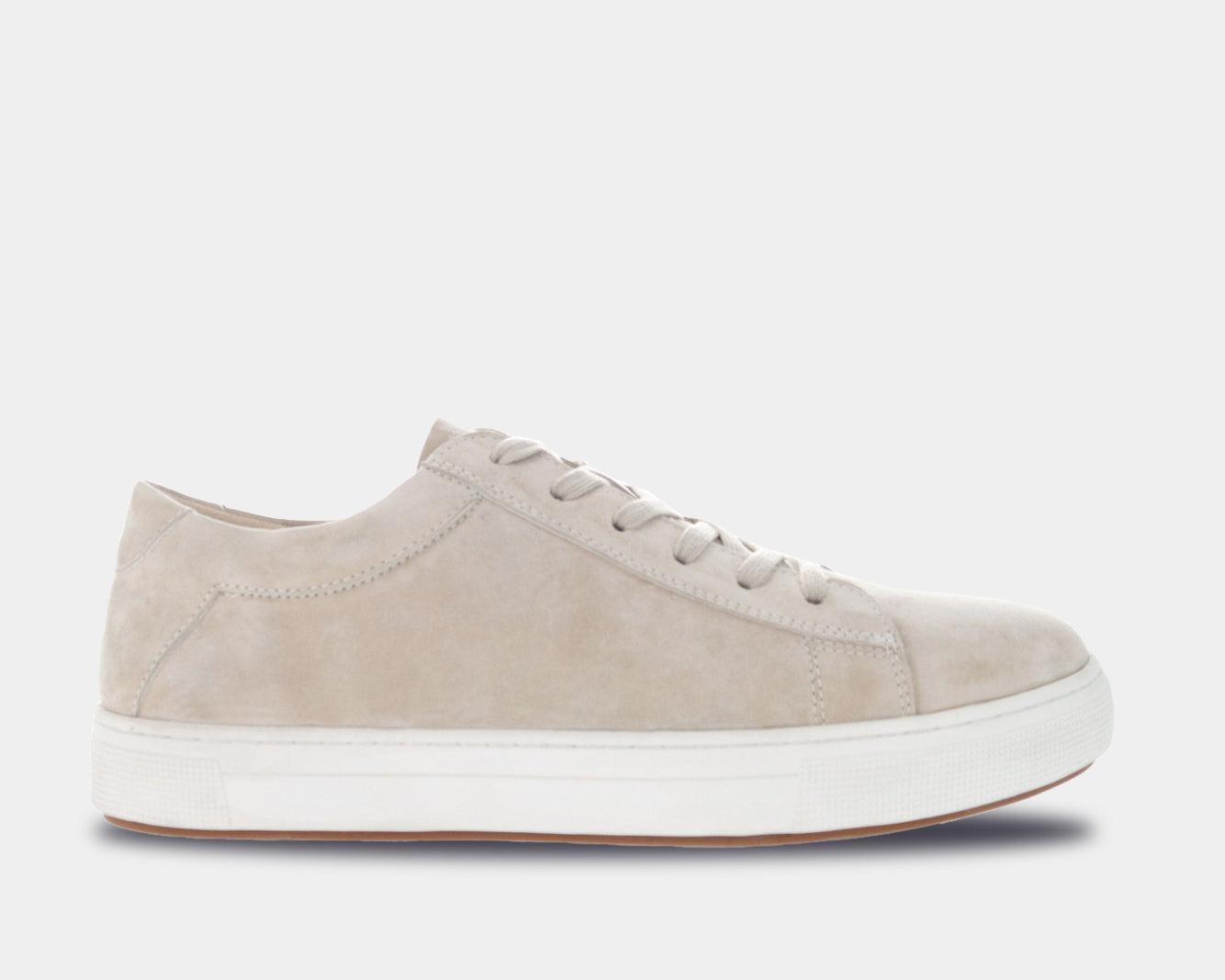 A beige suede sneaker with a lace-up closure, round toe, and a flat rubber cup outsole.