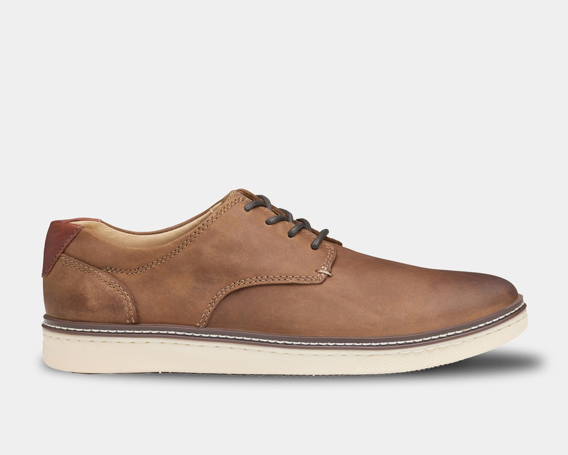 A tan sneaker with a plain toe style, featuring a lightweight construction and a contrast heel accent.