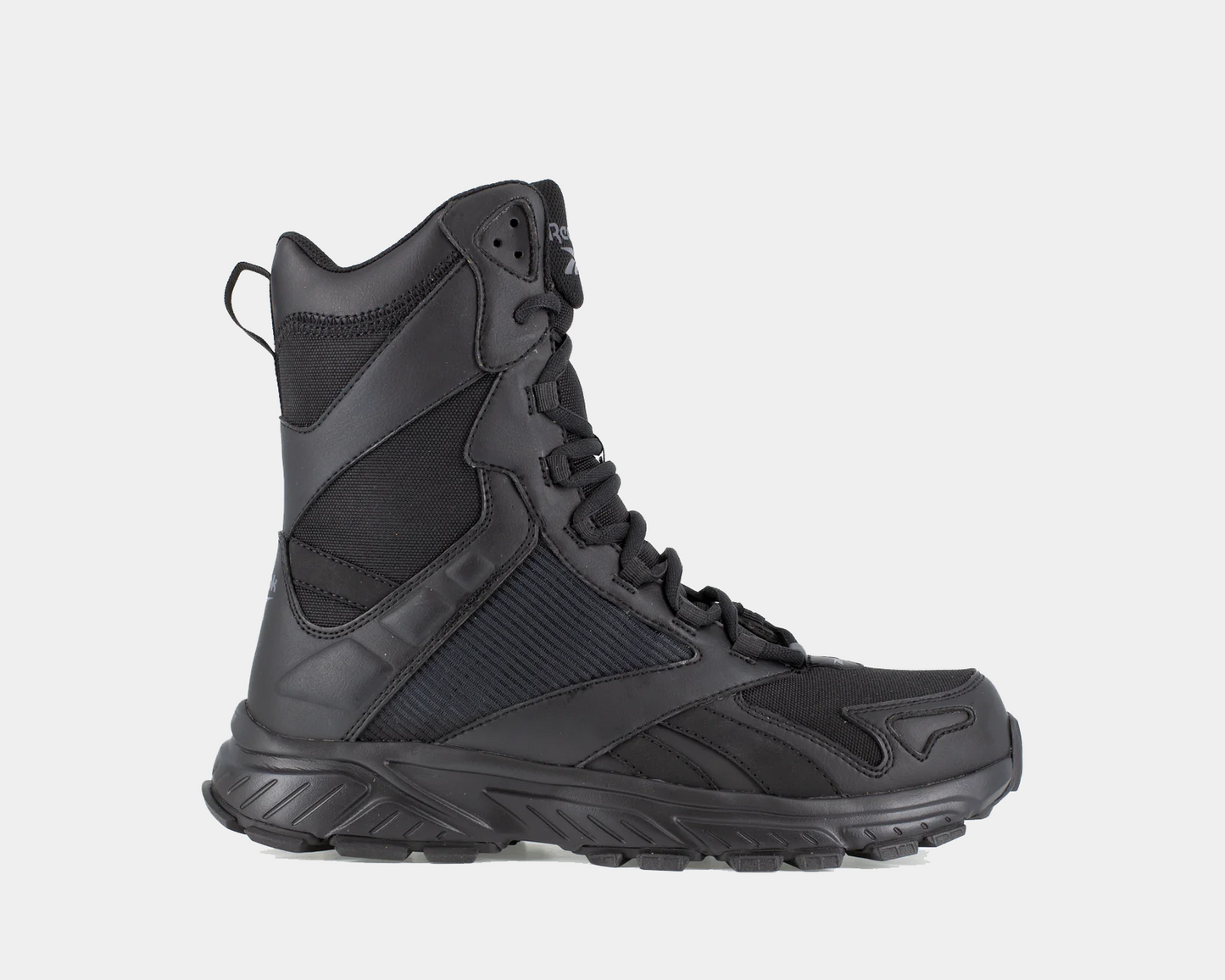 A black tactical trail running boot with a side zipper, designed for stable footing and comfort on rugged terrain.