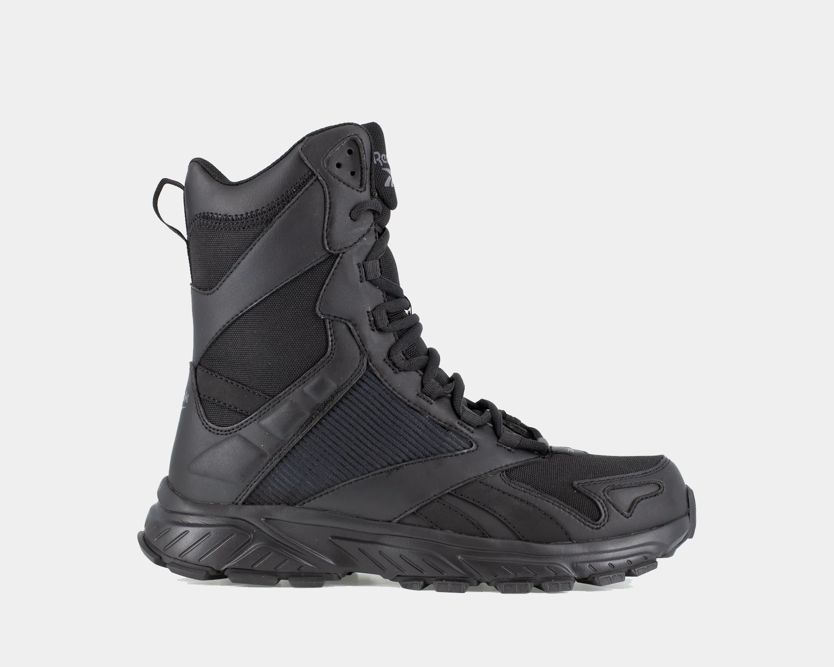 A black tactical trail running boot with a side zipper, designed for stable footing and comfort on rugged terrain.