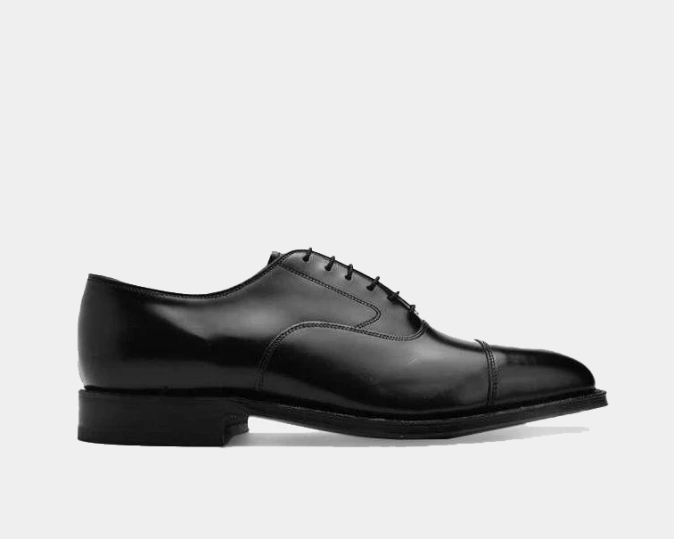 A black leather dress shoe with a lace closure.
