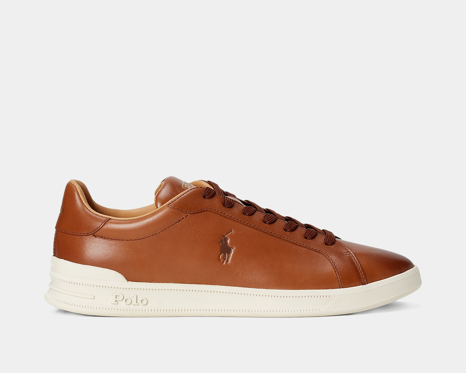 A brown leather sneaker with a lace-up front, rounded toe, and a white textured rubber outsole. It features a signature Pony emboss at the outer side and has 'Polo' printed at the tongue.