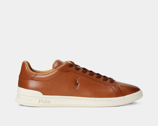 A brown leather sneaker with a lace-up front, rounded toe, and a white textured rubber outsole. It features a signature Pony emboss at the outer side and has 'Polo' printed at the tongue.
